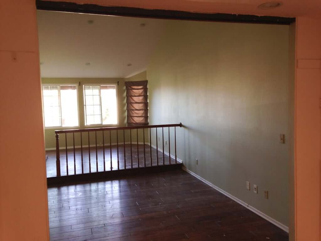 view of bedroom with railing from inside walk in closet