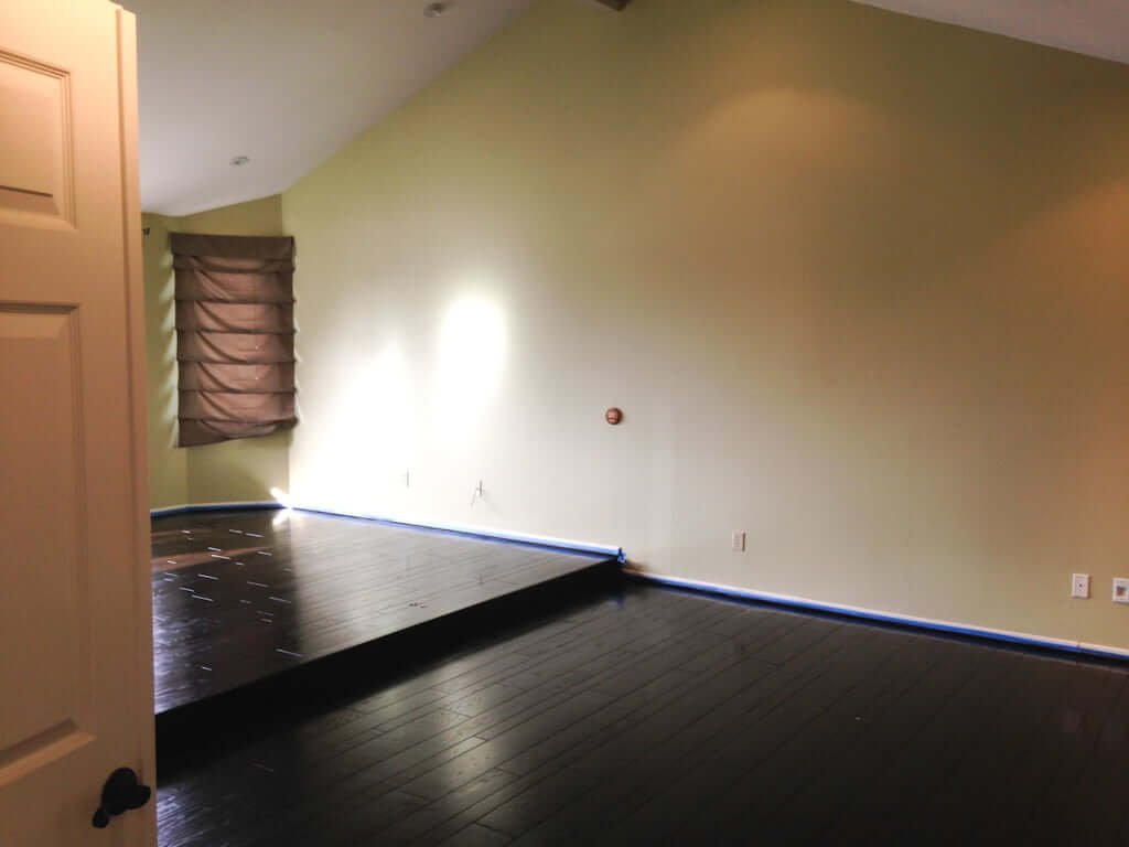 bedroom with dark hardwood floors and high ceilings