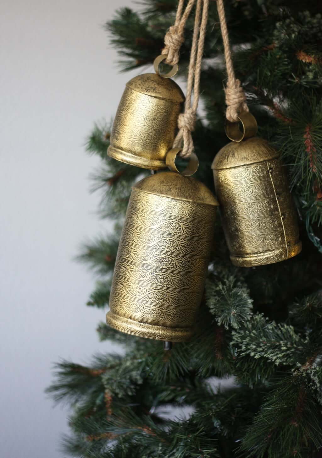 metal Christmas bells on simple Christmas tree