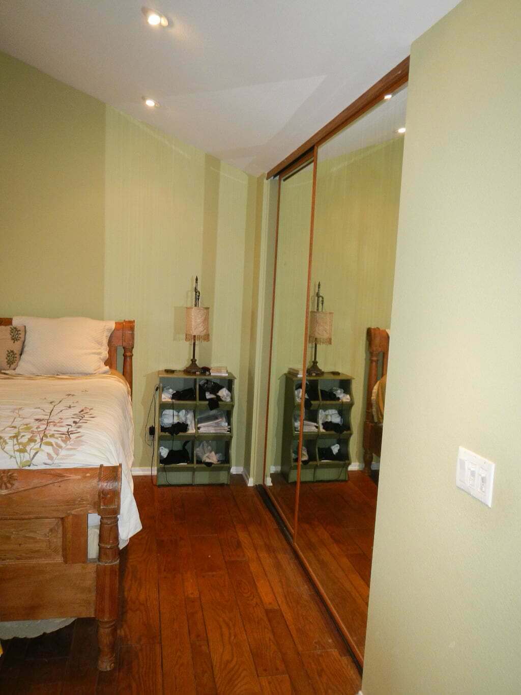 bedroom corner before with mirrored closet doors