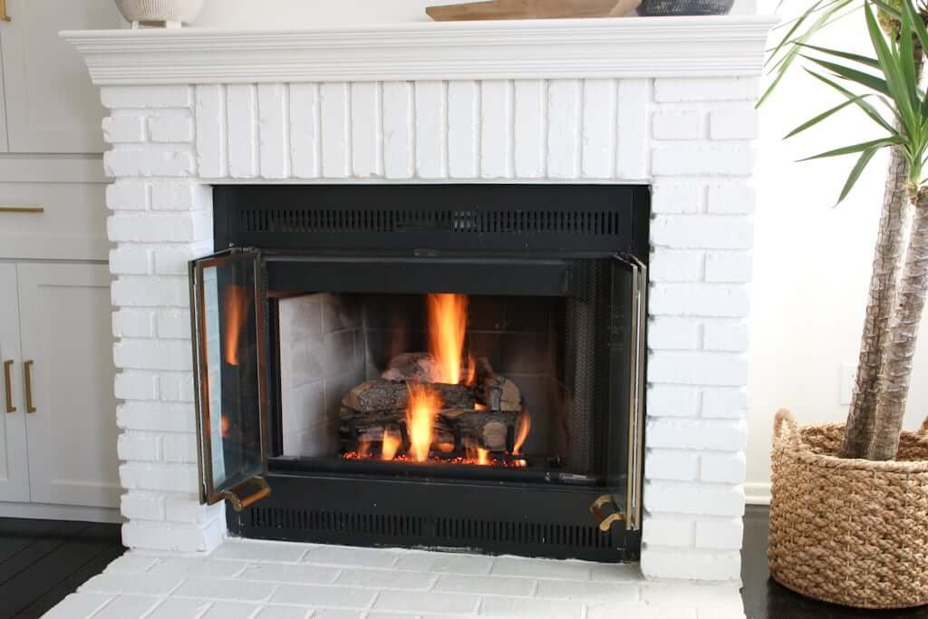 painted brick fireplace, white with gas fireplace insert