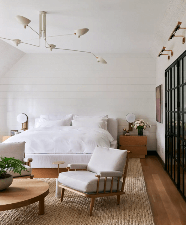 white and wood bedroom with horizontal wall planks and nothing hanging above bed