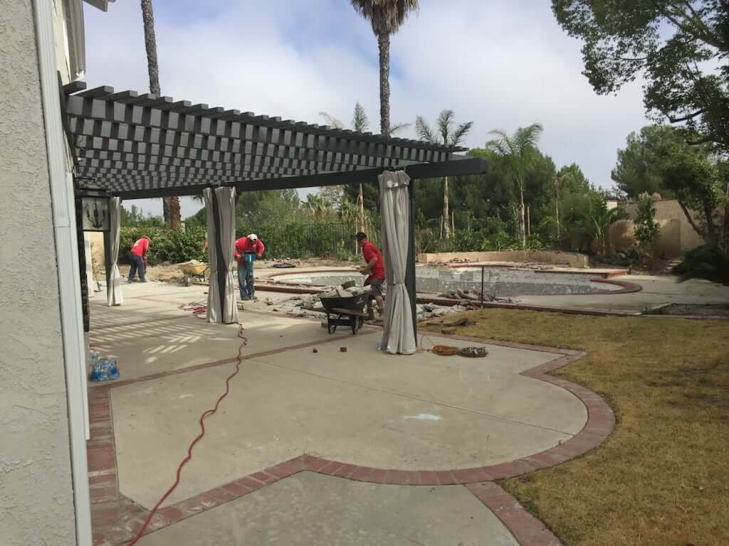 backyard with patio and arbor being demolished