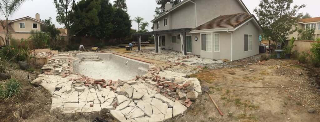 house and backyard with pool being demolished