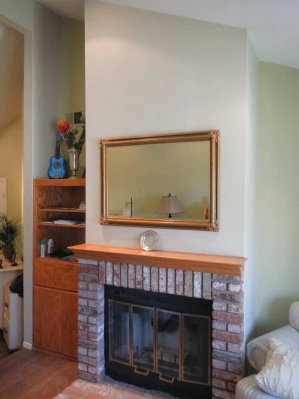 red brick fireplace before, with built in bookcase