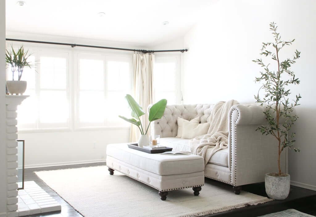 master bedroom with sitting area and fireplace, with couch