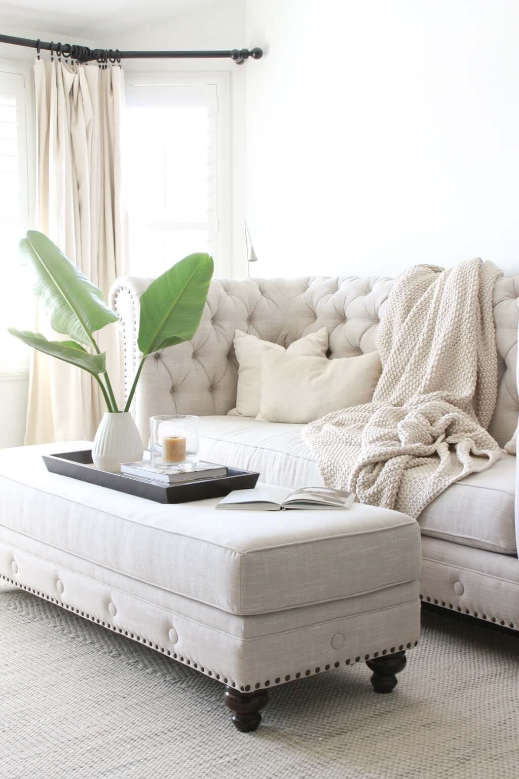 tufted couch with ottoman, ottoman styling with tray and plant