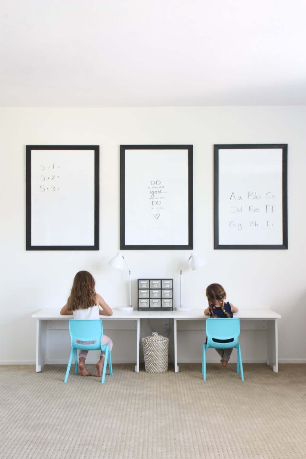 three DIY clear dry erase board frames above kids desk