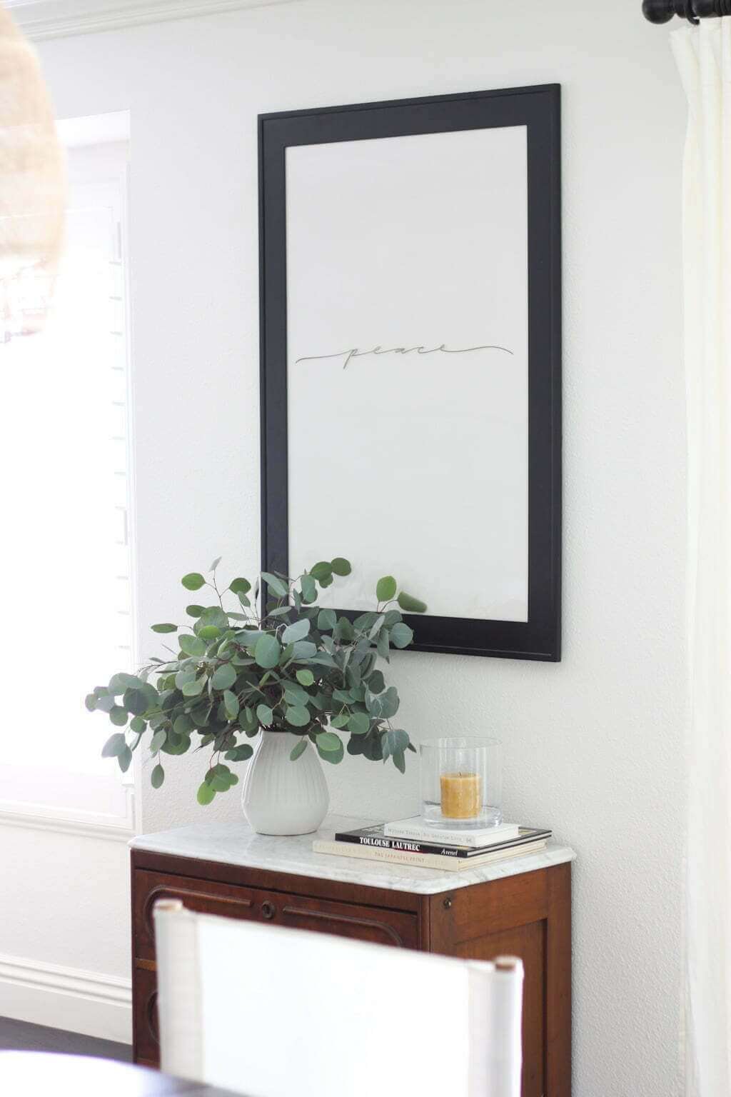 DIY glass whiteboard frame with hand scripted word in dining room