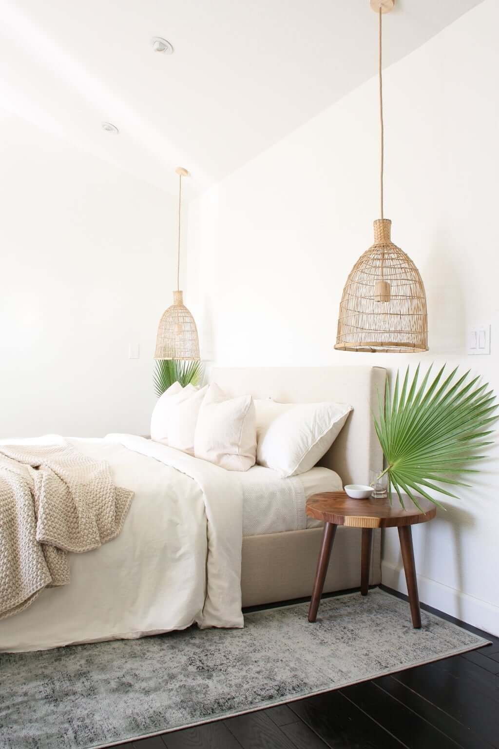 upholstered bed in bedroom with dark vs light hardwood floors