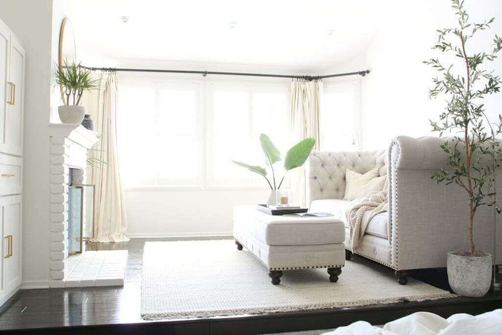 bedroom sitting area with dark hardwood floors and light rugs