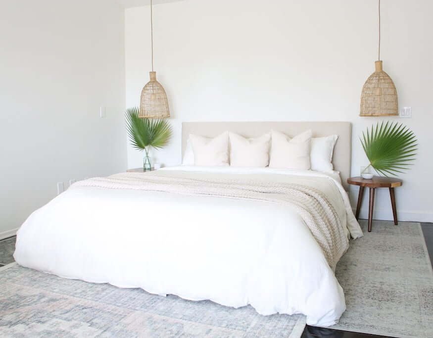 master bedroom showing bed with woven pendant lights