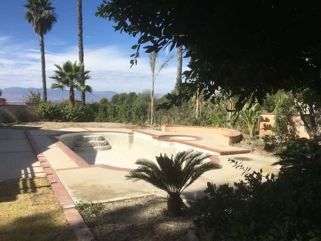 backyard under remodel with pool being resurfaced