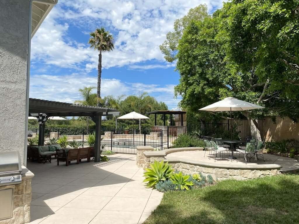 backyard patio with raised patio with retaining wall