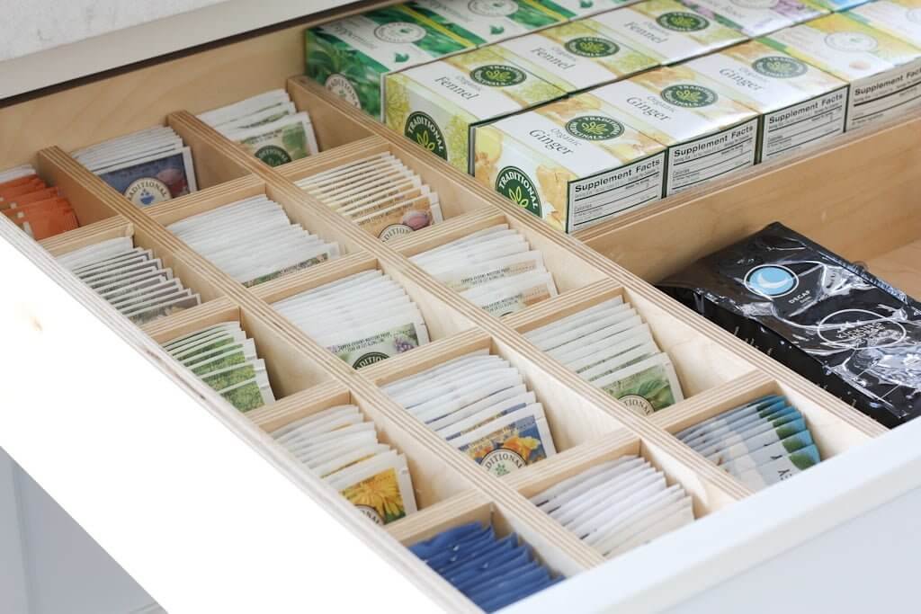 tea drawer organized by wood dividers, both tea bags and tea boxes