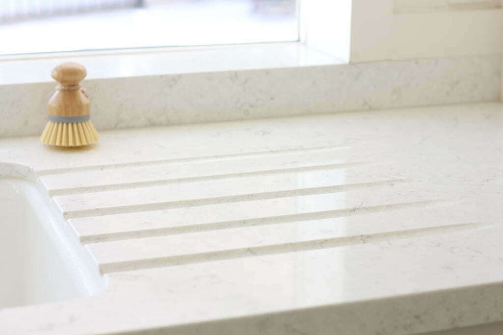 built in countertop drain grooves in white quartz countertop