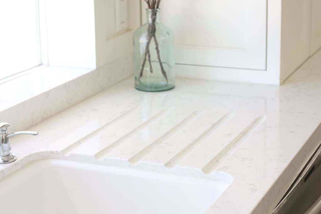 built in countertop runnels in white quartz next to sink