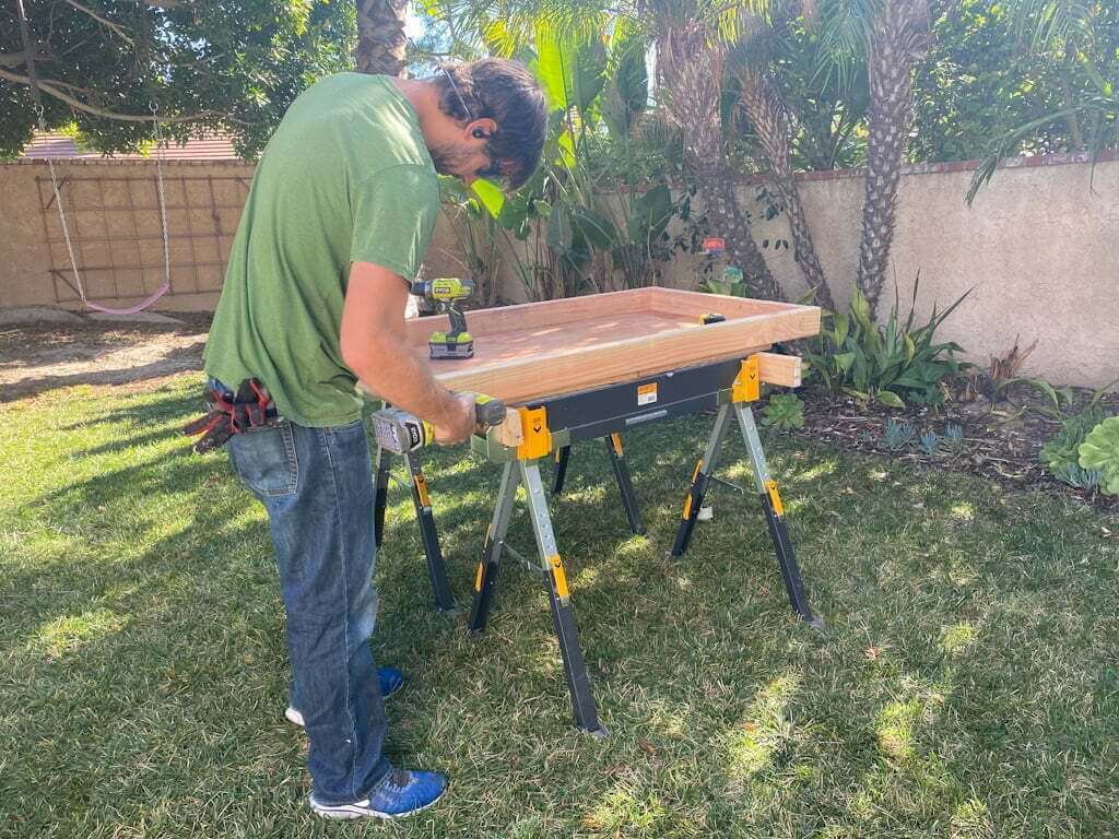 man building diy rug ottoman frame