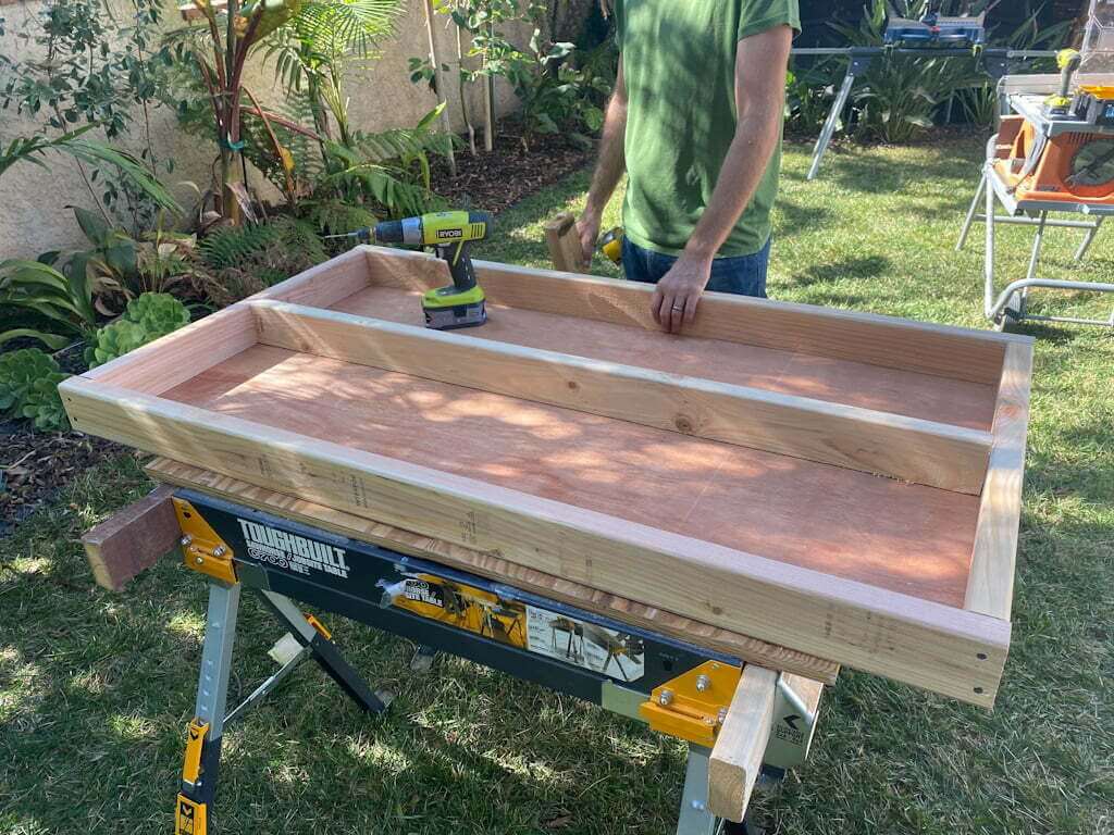man building easy DIY ottoman frame