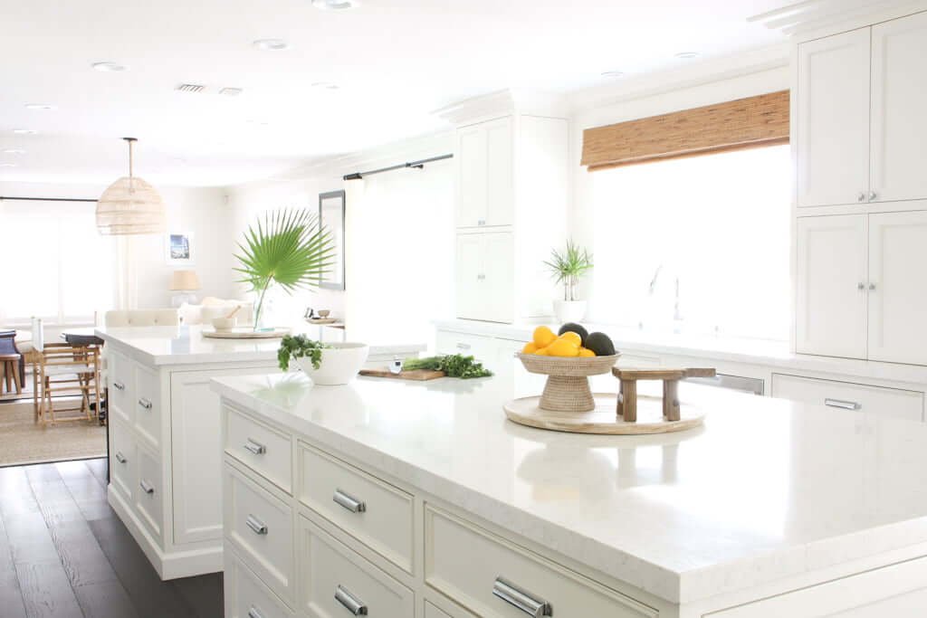 kitchen with raised countertops on two islands and sink in background