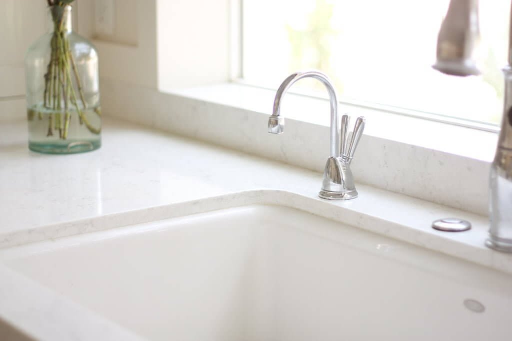 instant hot water dispenser in quartz countertop with white sink