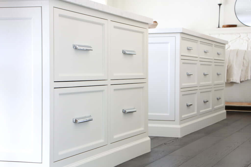 white kitchen island drawers with dark wood floors