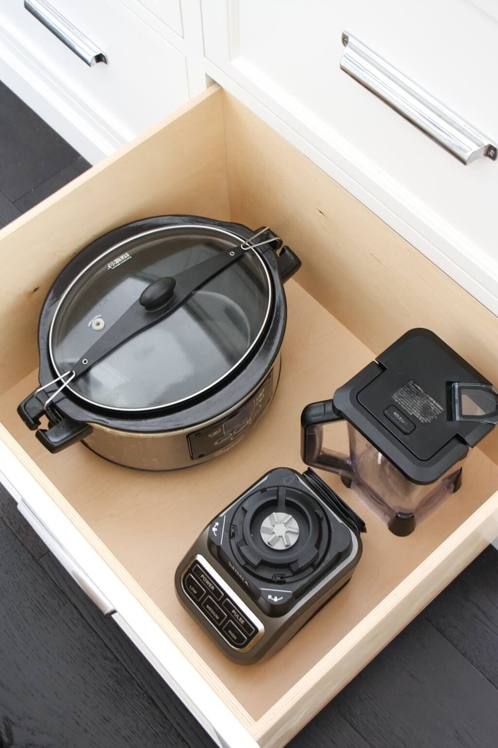 kitchen appliance storage drawers with blender and slow cooker inside