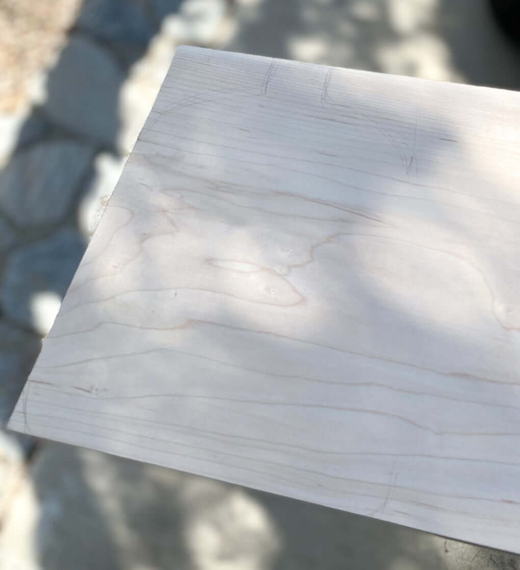 closeup of wood cutting board with pencil marks