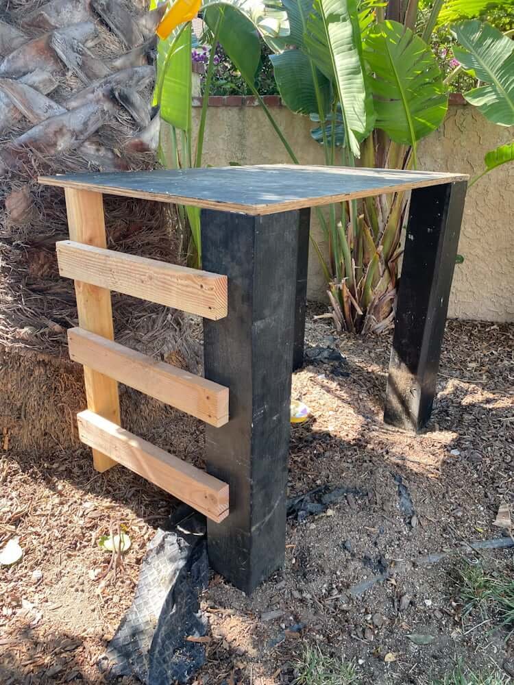 backyard zipline platform being built, mismatched wood colors black and raw wood