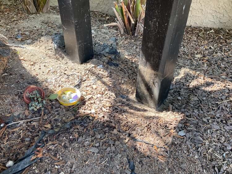 closeup of backyard zipline platform posts slightly sunk into ground