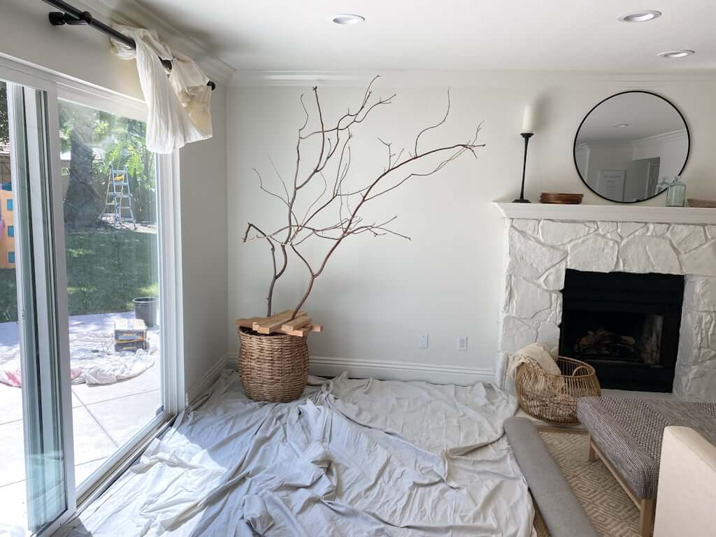 DIY fake tree branches in basket in living room