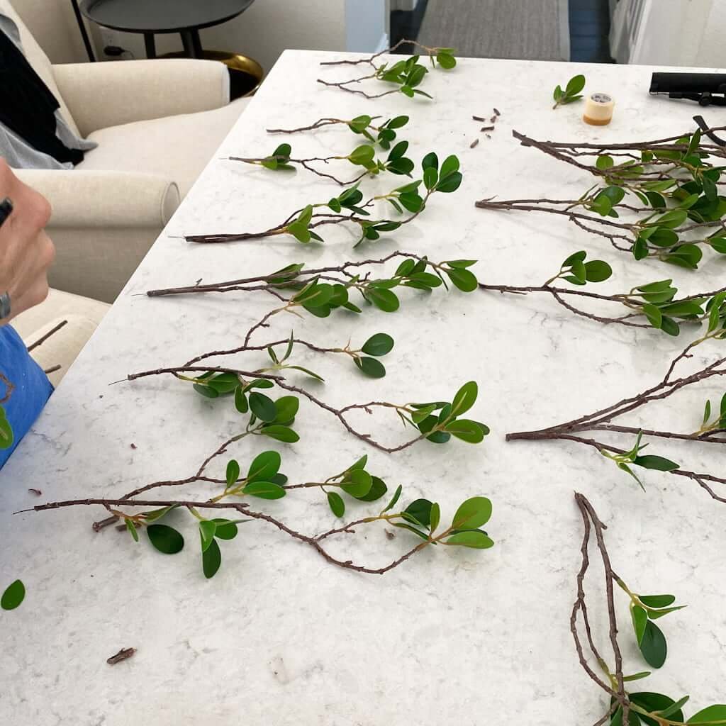 artificial tree branches laid out on counter by size