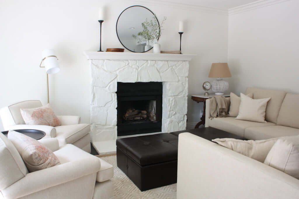 neutral living room with white stone painted fireplace