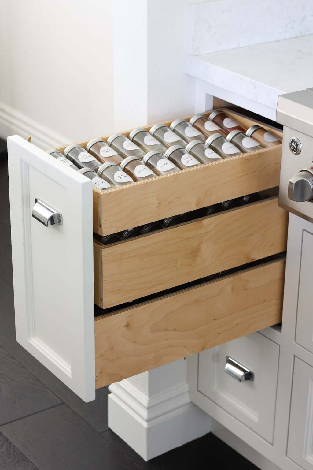 pull out spice rack made of wood, vertical under cabinet near stove