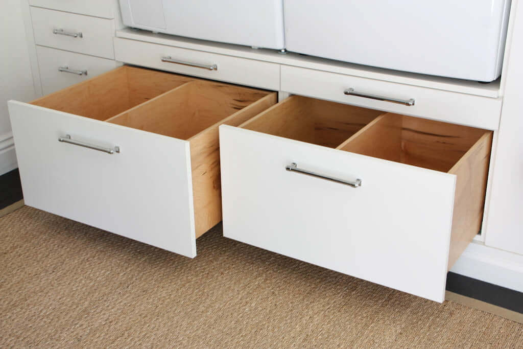large DIY storage drawers below washer and dryer in laundry room makeover