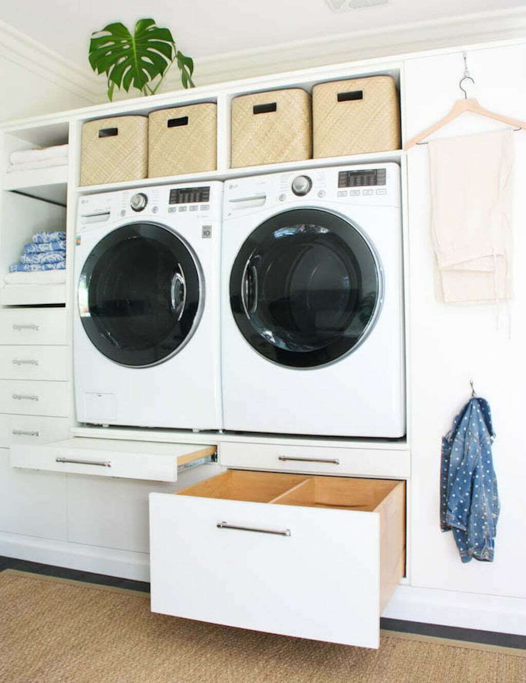 DIY laundry room makeover with organization and baskets and storage drawers under washer and dryer machines