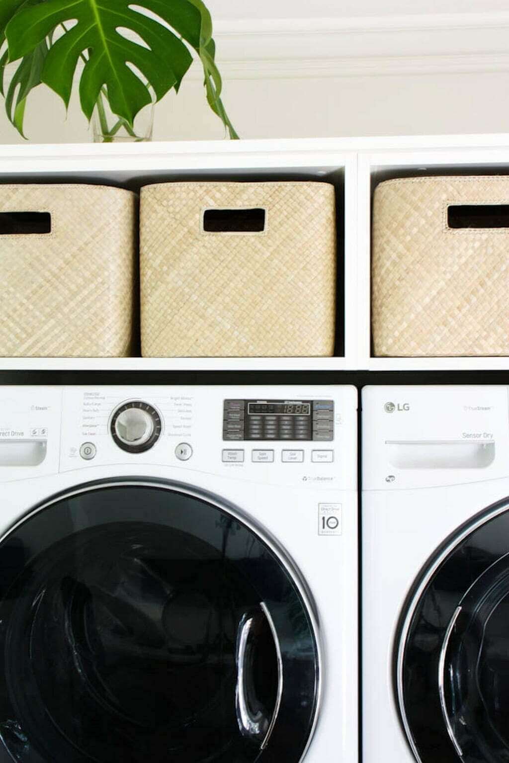 small laundry room makeover ideas with woven baskets above washer and dryer