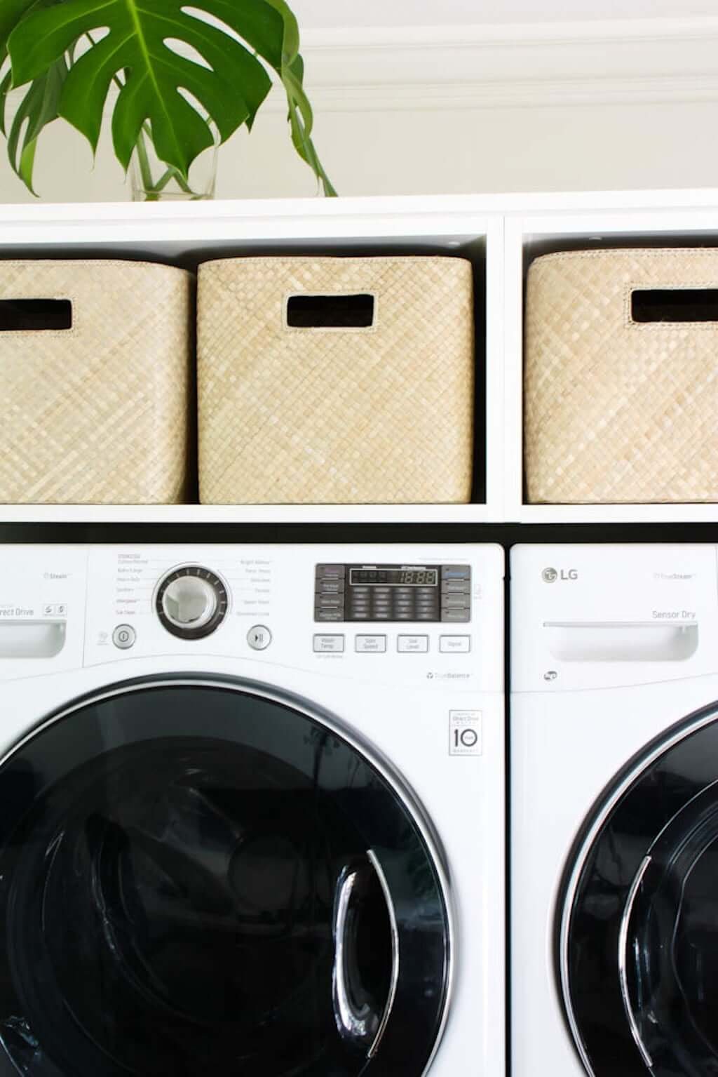 laundry room shelves with laundry baskets above washer and dryer