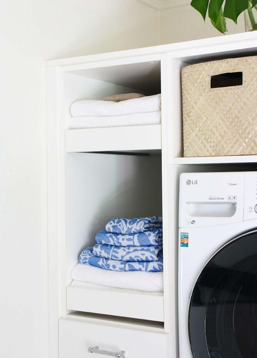 small laundry room makeover idea with full-extension drawers with folded towels on them