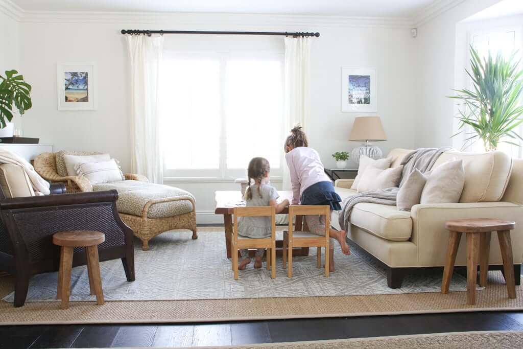 children doing a puzzle in living room with hidden TV lift cabinet