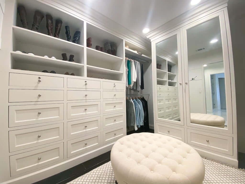 master closet ideas with white drawers, shelves, hanging space and ottoman