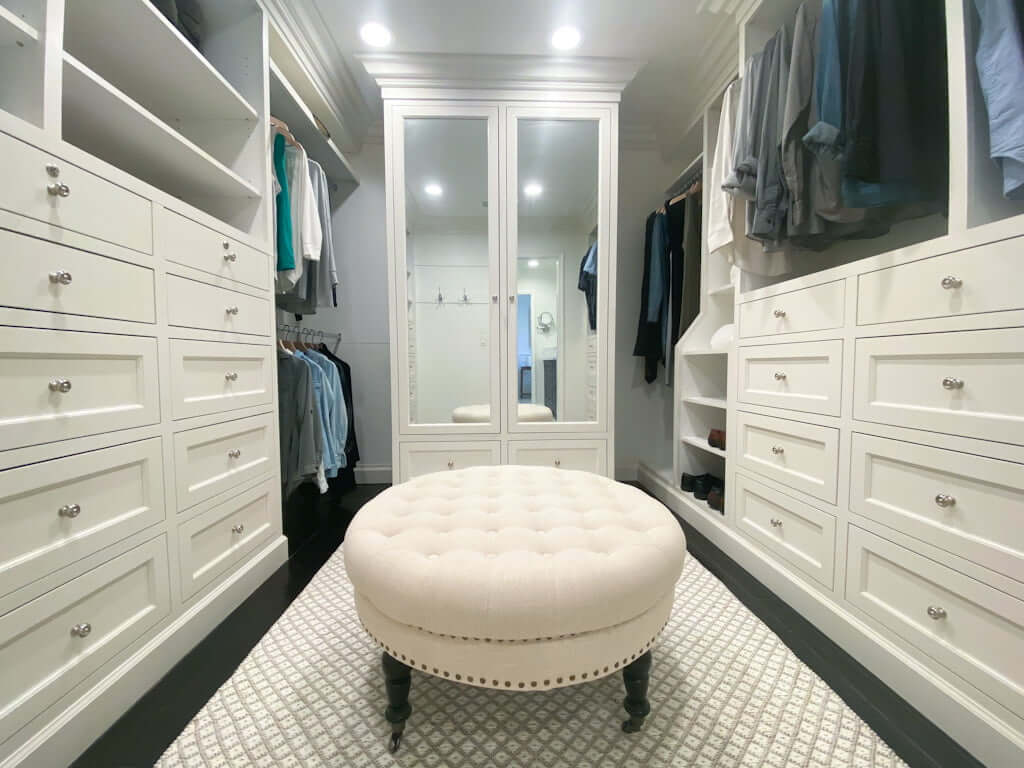 master closet design ideas with ottoman and white cabinets and white drawers