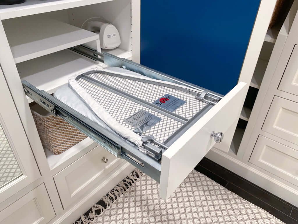 folding ironing board drawer pulled out and folded down in closet cabinet from Rev-a-Shelf