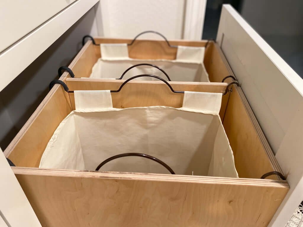 built in hamper in closet with double sorting laundry hamper bags attached in drawer