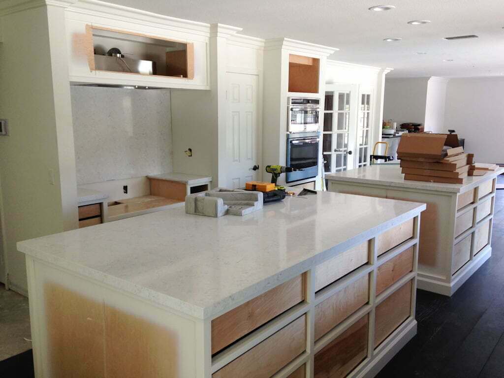 white kitchen after quartz countertops and backsplash installed
