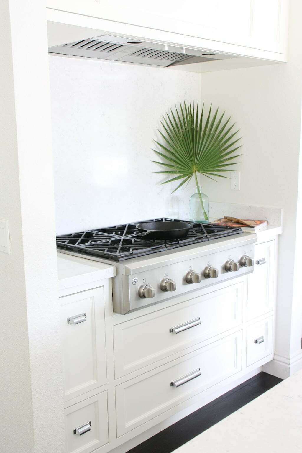 white quartz slab backsplash behind range stove in white kitchen, solid surface