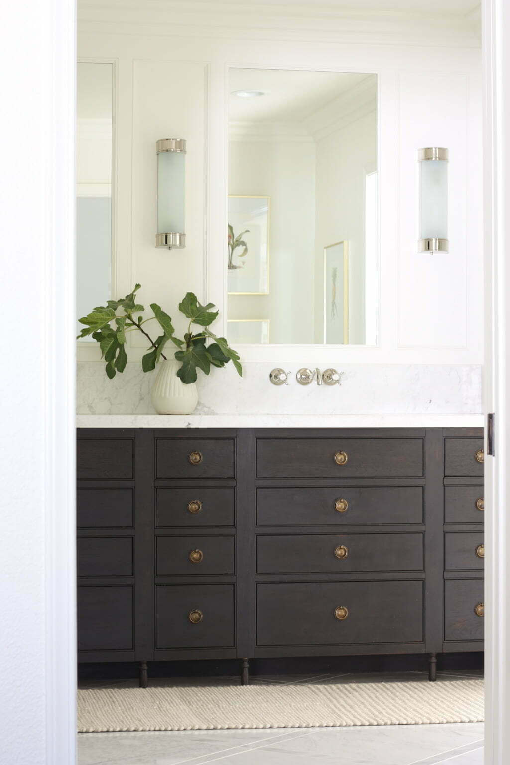 Traditional bathroom with a wooden double vanity, marble top and bathroom vanity lights chrome.