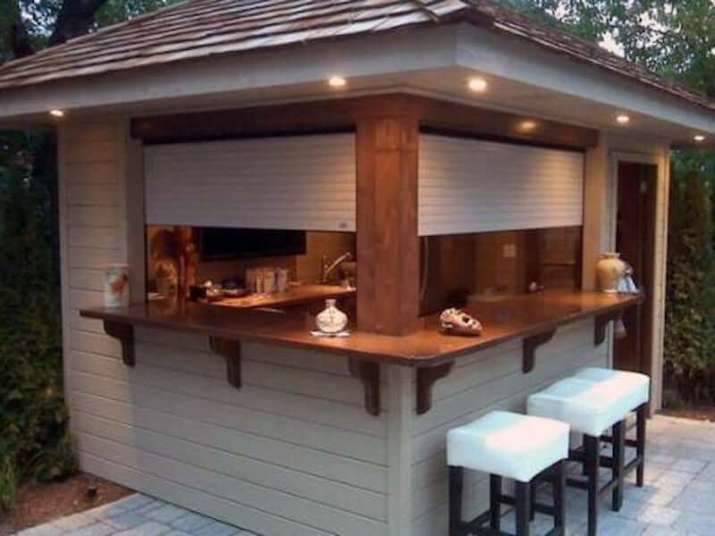 backyard bar shed with blinds, roof, and patio bar stools