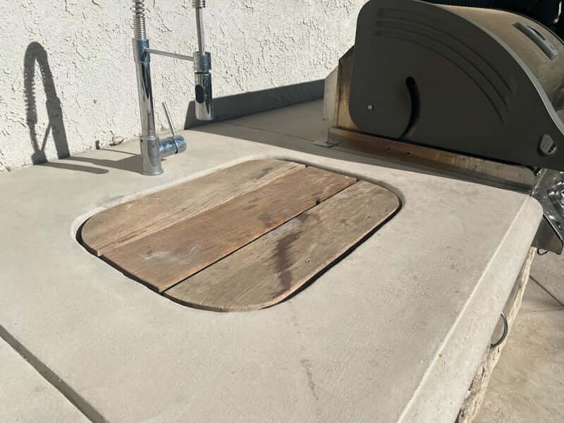 wood sink cover in outdoor kitchen with concrete countertops