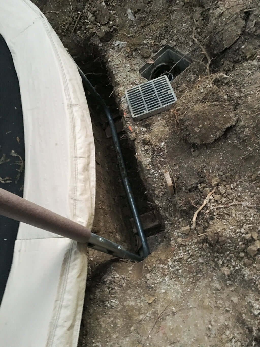 in-ground trampoline sunken into ground with holes